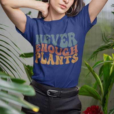 Navy t-shirt featuring the design Never Enough Plants in bold green text with leafy detail.