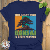 Navy t-shirt featuring the design “Time spent with bonsai is never wasted” with a bonsai plant print, classic casual wear nature lovers.