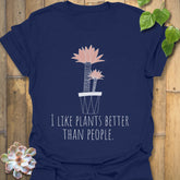 Navy t-shirt showing the phrase “I like plants better than people” alongside a flower in a pot print