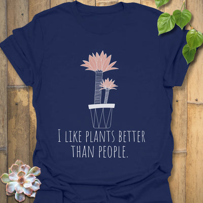 Navy t-shirt showing the phrase “I like plants better than people” alongside a flower in a pot print