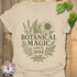 Sand t-shirt featuring the design Botanical Magic printed in bold letters, floral graphic tee.