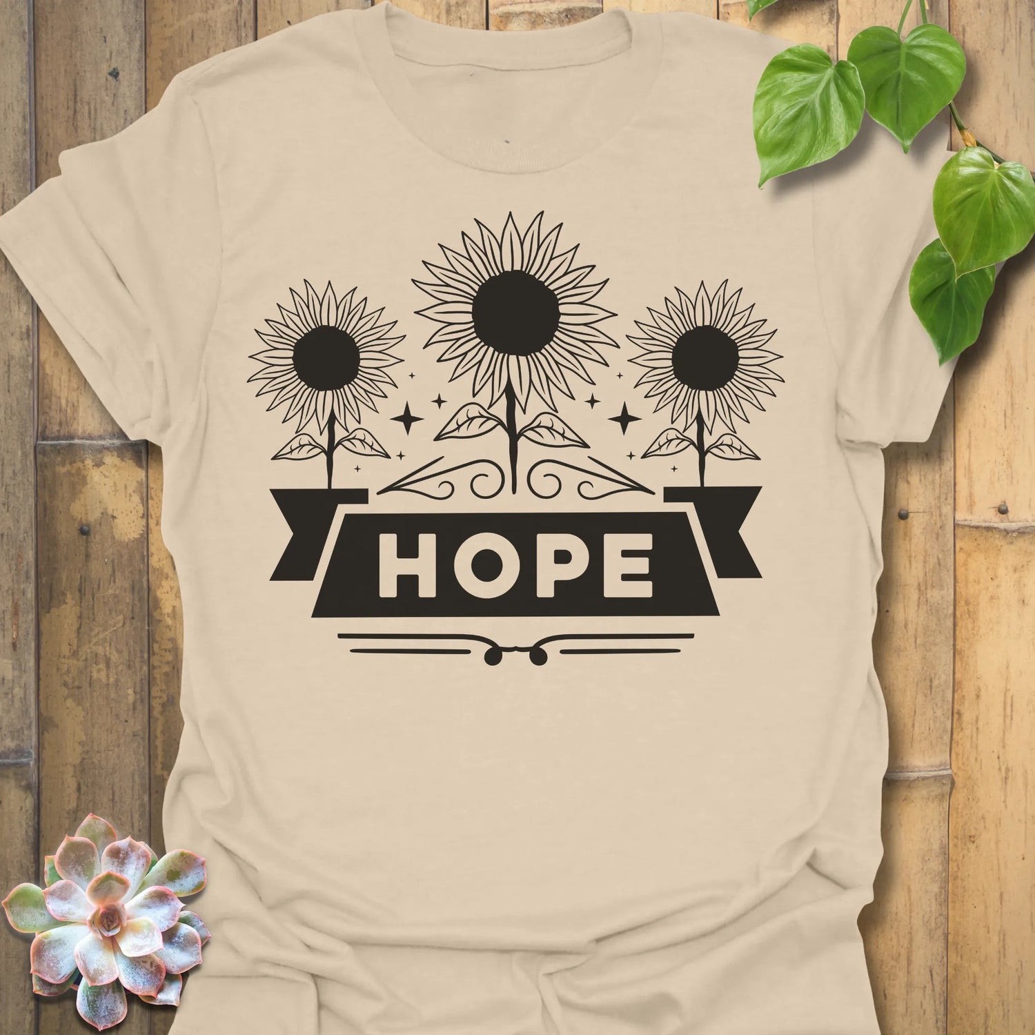 Sand t-shirt featuring the design Hope printed in sunflower and bold letters, positive vibe t-shirt.