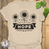 Sand t-shirt featuring the design Hope printed in sunflower and bold letters, positive vibe t-shirt.