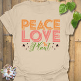 Sand t-shirt featuring the design Peace Love Plant printed in bold letters, gardening lover shirt.