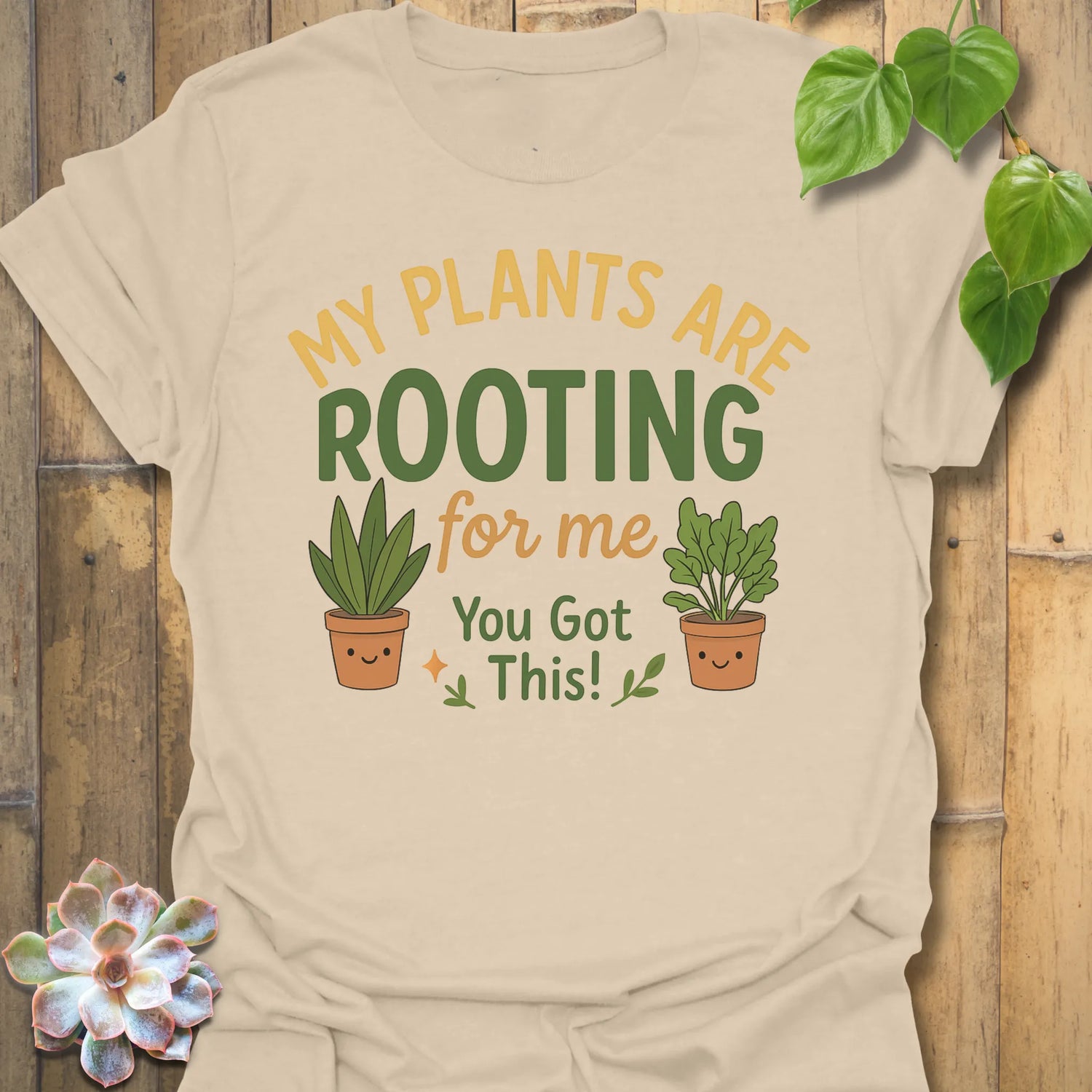 Sand t-shirt featuring the design Plants Are Rooting printed in bold letters, gardening graphic tee.