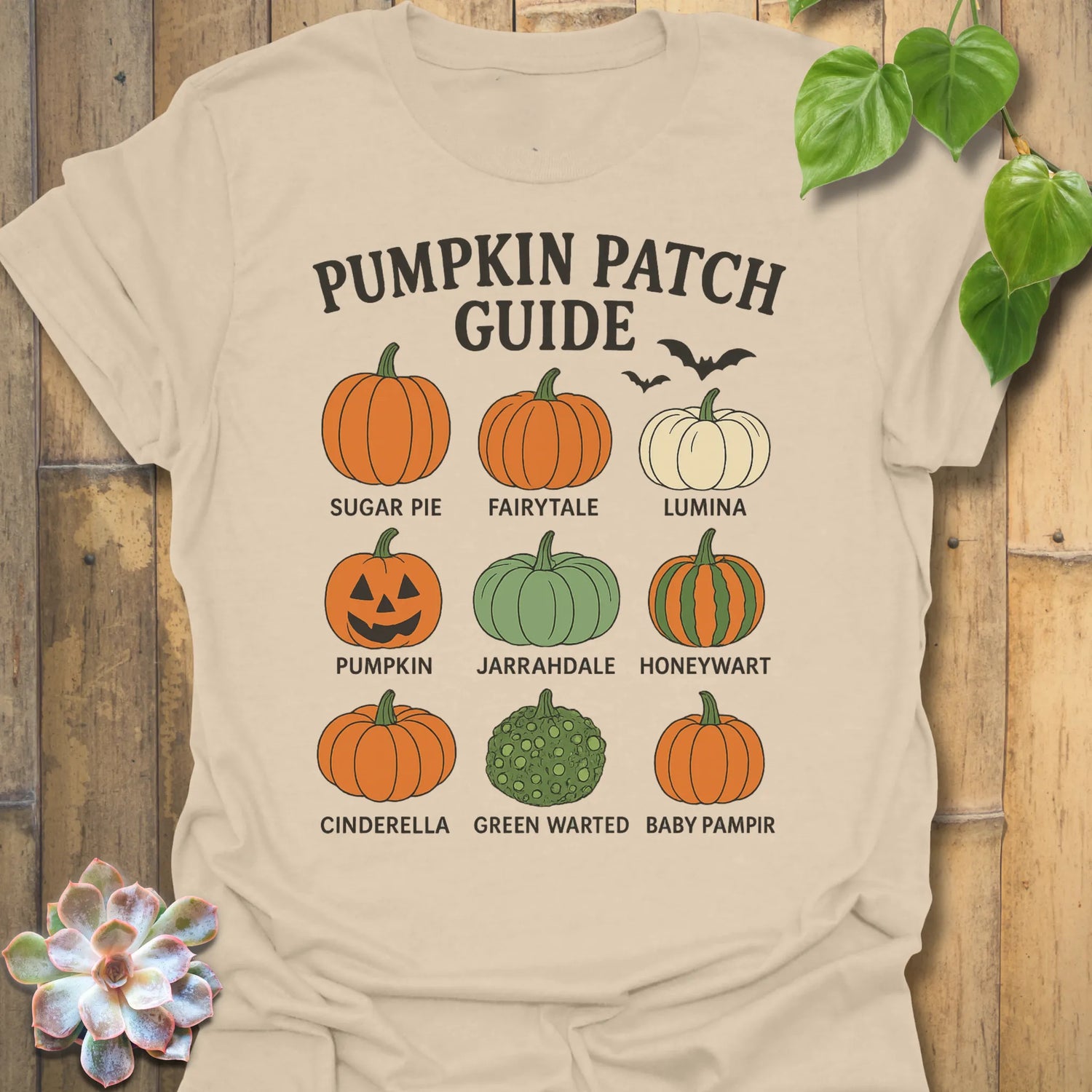 Sand t-shirt featuring the design Pumpkin Patch Guide printed in black letters, Halloween pumpkin tee.
