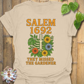 Sand t-shirt featuring the design Salem 1692 printed in bold letters, vintage halloween graphic tee.