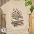 Sand t-shirt featuring the design Whiskers & Words printed in books and cats with flowers, cat lover reading shirt.