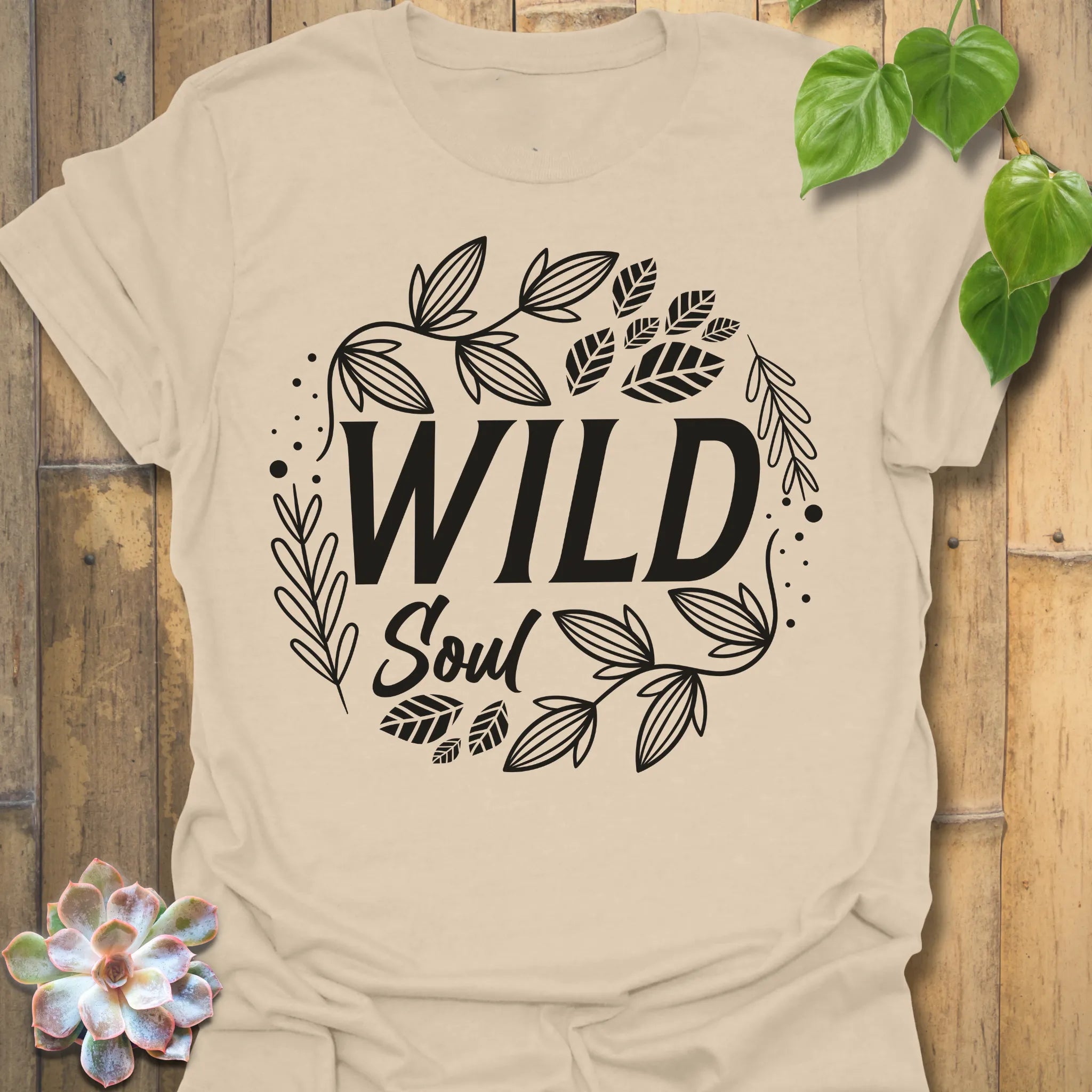 Sand t-shirt featuring the design Wild Soul printed in bold white letters, nature-inspired shirt.