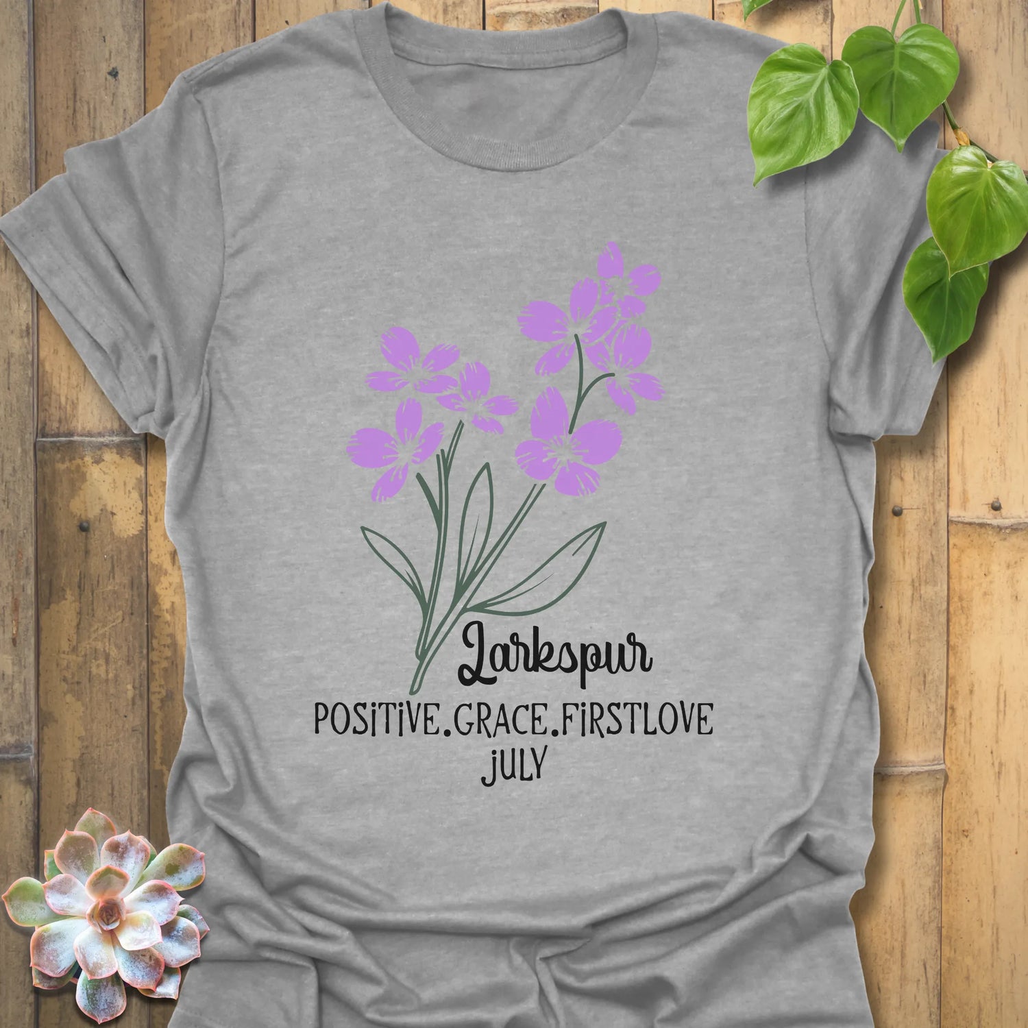 Sport Grey t-shirt featuring the design July Larkspur with a bold larkspur flower artwork, a versatile floral graphic t-shirt for everyday wear and botanical clothing lovers.