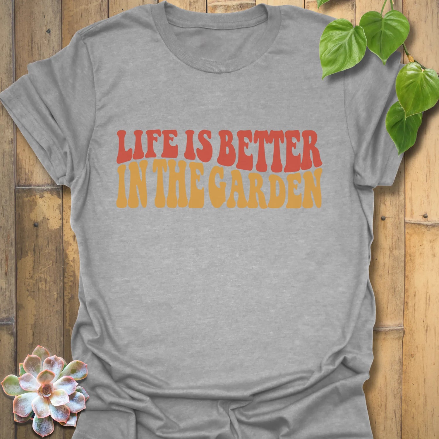 Sport Grey t-shirt featuring the design Life is better in the garden printed in green floral lettering, comfortable unisex gardening graphic tee