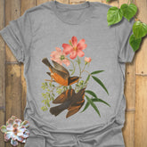 Sport grey t-shirt displaying the Spring Songbirds design of two perched birds with pink flowers and green leaves.