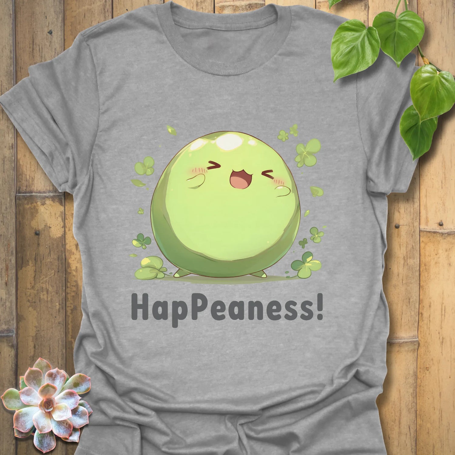 Sport grey t-shirt with a happy pea illustration surrounded by clovers and the text “HapPeaness!”