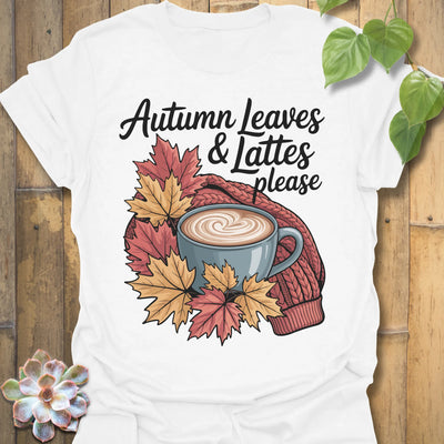 White t-shirt featuring the design Autumn Leaves &amp; Lattes printed in cosy fall shirt for coffee lovers.