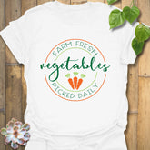 White t-shirt featuring the design Farm Fresh Vegetables Picked Daily with colourful produce graphic, organic food shirt.