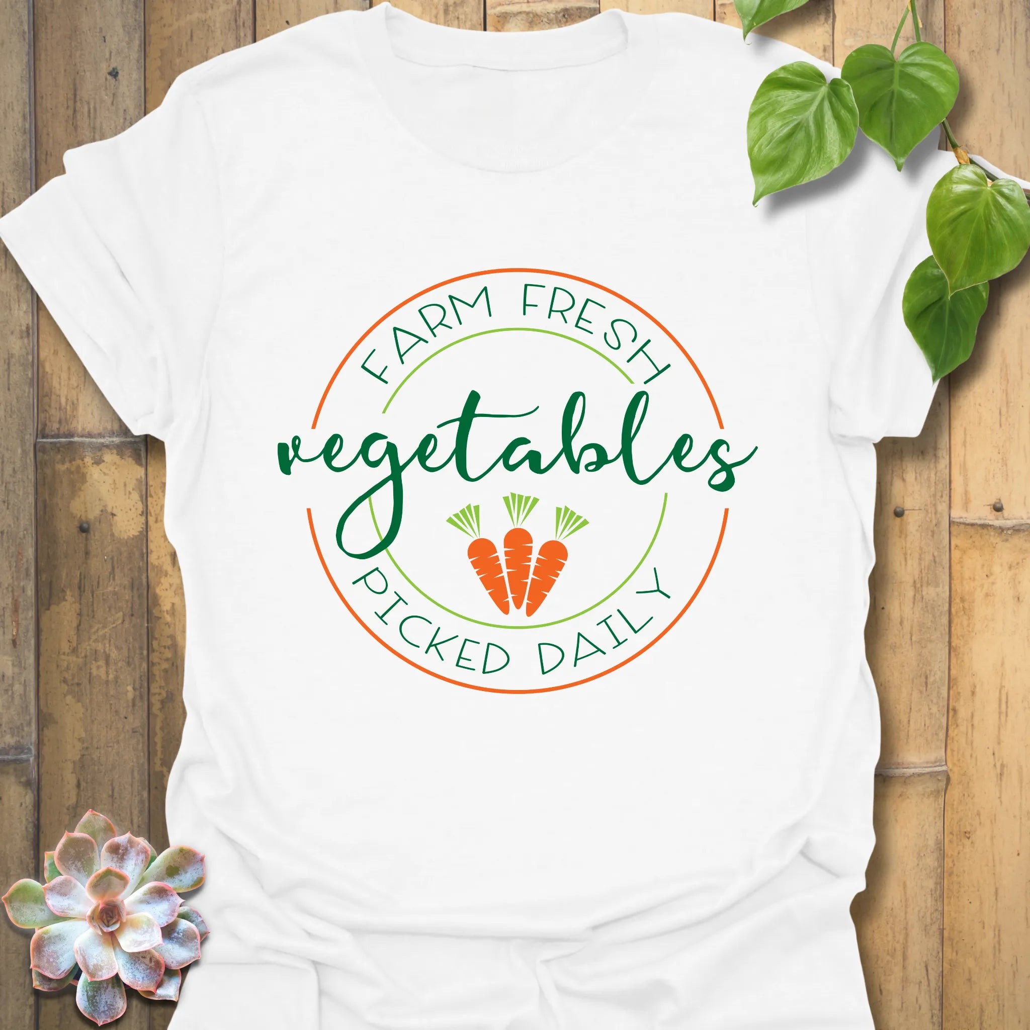 White t-shirt featuring the design Farm Fresh Vegetables Picked Daily with colourful produce graphic, organic food shirt.