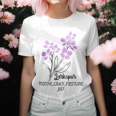 White t-shirt featuring the design July Larkspur with a delicate larkspur flower print, perfect for floral graphic tee lovers and botanical fashion enthusiasts.