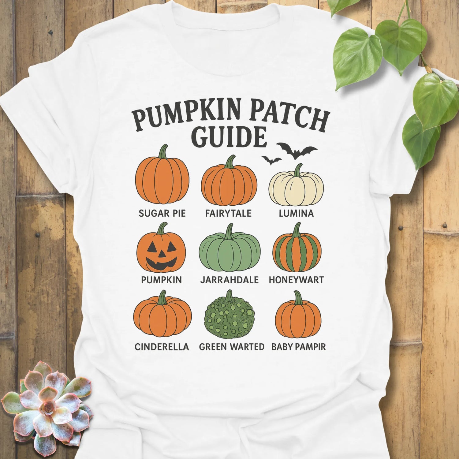 White t-shirt featuring the design Pumpkin Patch Guide printed in black letters, Halloween pumpkin tee.