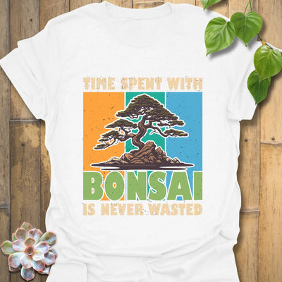 White t-shirt featuring the design “Time spent with bonsai is never wasted” with a bonsai plant print, perfect for bonsai lovers and casual wear.