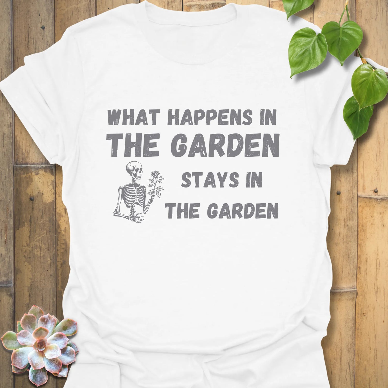 White t-shirt featuring the design What Happens in the Garden Stays in the Garden, perfect gardening graphic tee.