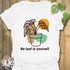 White t-shirt featuring the words “Be-leaf in yourself” along with a green plant in a pot design