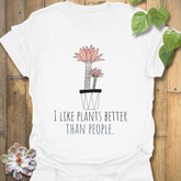 White t-shirt with the design “I like plants better than people” and a flower in a pot graphic