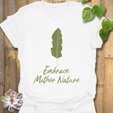 White t-shirt with the words “Embrace Mother Nature” and a minimal leaf print graphic
